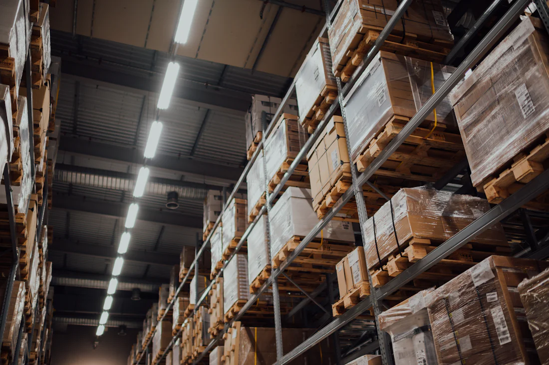 Warehouse racking stacked with palletised and shrink-wrapped cargo